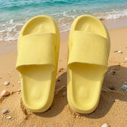Yellow rubber platform slides shoes from Shop Lev, featuring thick soles and open-toe design for casual summer wear.
