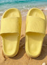 Yellow rubber platform slides shoes from Shop Lev, featuring thick soles and open-toe design for casual summer wear.