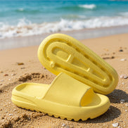 Yellow rubber platform slide shoes from Shop Lev, featuring a chunky sole and open-toe design.