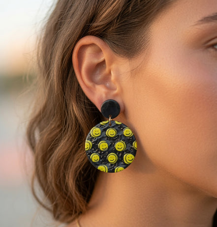 Avenue Zoe Happy Face Dangles earrings featuring cheerful smiley face charms hanging from silver hooks.