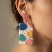 Avenue Zoe rectangular abstract dangle earrings with geometric design in silver and black on a white background.