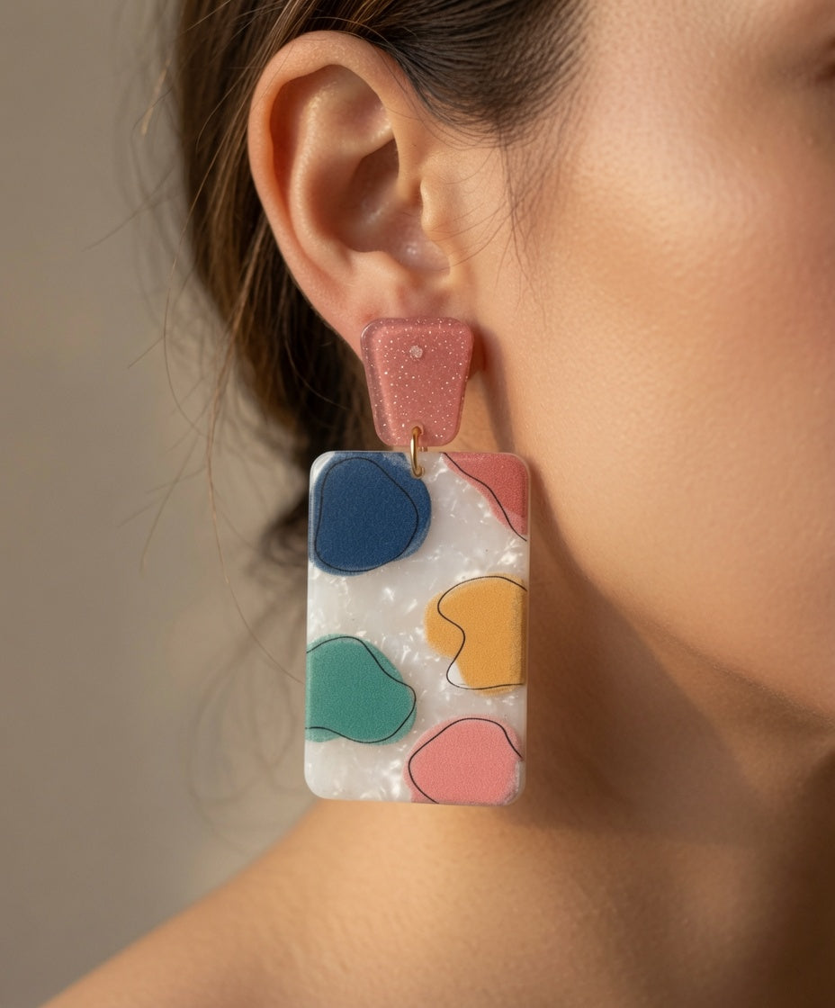 Avenue Zoe rectangular abstract dangle earrings with geometric design in silver and black on a white background.