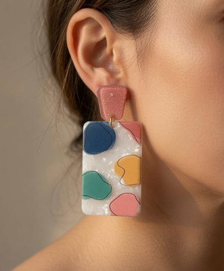 Avenue Zoe rectangular abstract dangle earrings with geometric design in silver and black on a white background.