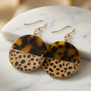 Avenue Zoe tortoise and cheetah print dangle earrings with gold hooks, showcasing a stylish animal print design.