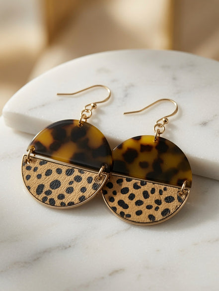 Avenue Zoe tortoise and cheetah print dangle earrings with gold hooks, showcasing a stylish animal print design.