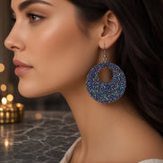 Round plum sparkle earrings from A Glamper’s Creations, LLC, featuring shimmering purple jewelry with a polished, elegant finish.