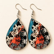 Colorful cow print earrings from Earring Babe Boutique, vibrant jewelry accessory with playful cow pattern detail.