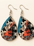 Colorful cow print earrings from Earring Babe Boutique, vibrant jewelry accessory with playful cow pattern detail.