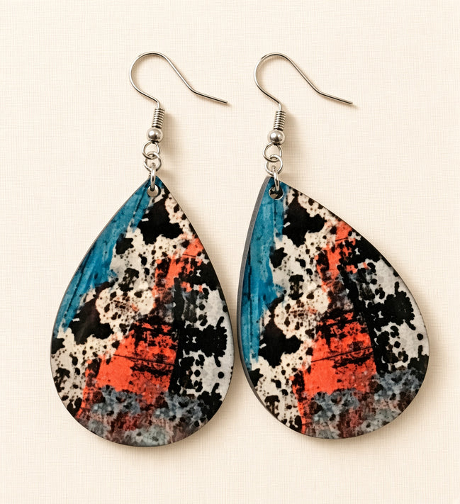 Colorful cow print earrings from Earring Babe Boutique, vibrant jewelry accessory with playful cow pattern detail.