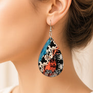 Colorful cow print earrings from Earring Babe Boutique, vibrant jewelry with playful cow pattern and bright colors.