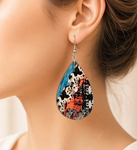 Colorful cow print earrings from Earring Babe Boutique, vibrant jewelry with playful cow pattern and bright colors.