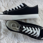 FASHION EMPORIO classic black sneakers showing a sleek, low-top design with white rubber soles and stylish laces.