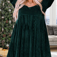 Black velvet babydoll dress with a square neckline and tie-back design, featuring long sleeves and a relaxed fit.