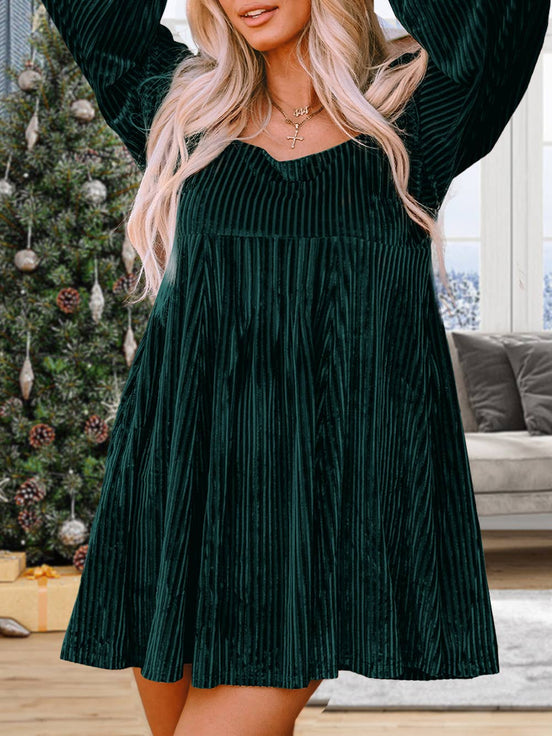 Black velvet babydoll dress with a square neckline and tie-back design, featuring long sleeves and a relaxed fit.