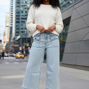 Aapparella wide leg jeans with flap pockets, cuffed hem, and relaxed fit, shown hanging on a white background.