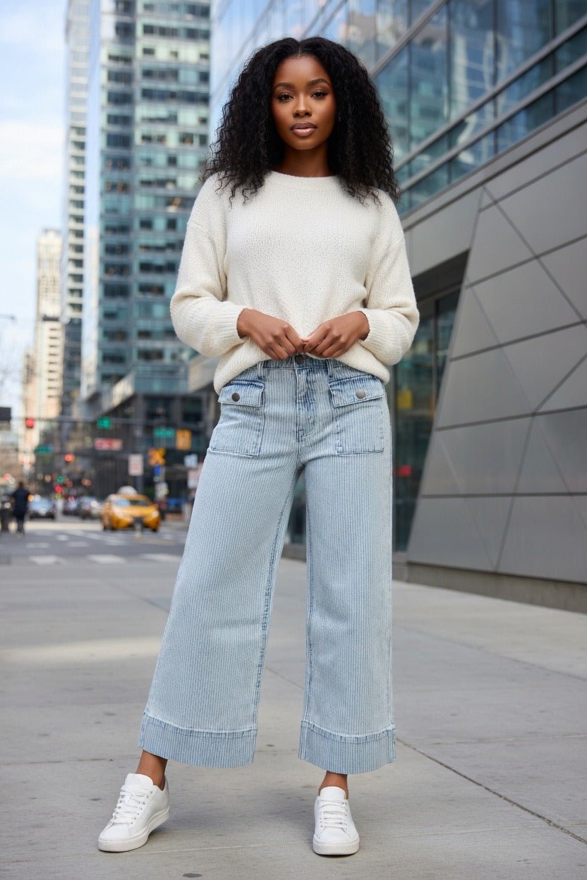 Aapparella wide leg jeans with flap pockets, cuffed hem, and relaxed fit, shown hanging on a white background.