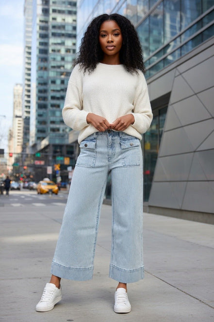 Aapparella wide leg jeans with flap pockets, cuffed hem, and relaxed fit, shown hanging on a white background.