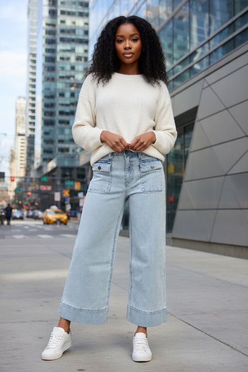 Aapparella wide leg jeans with flap pockets, cuffed hem, and relaxed fit, shown hanging on a white background.
