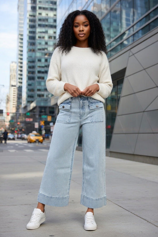 Aapparella wide leg jeans with flap pockets, cuffed hem, and relaxed fit, shown hanging on a white background.