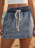 Light blue high waist denim skort by Aapparella with front pockets, casual style, and a relaxed fit.