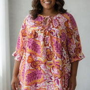 ADORA LA peasant floral top with a bohemian design, featuring colorful floral patterns and a relaxed fit.