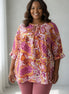 ADORA LA peasant floral top with a bohemian design, featuring colorful floral patterns and a relaxed fit.