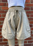 Khaki wide leg cargo shorts by ADORA LA, showing relaxed fit and multiple side pockets on lightweight fabric.