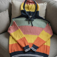 Multicolor hoodie sweater by ADORA LA featuring a cozy fit and vibrant color block design.