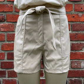Black faux leather shorts by And The Why, featuring a high-waisted design and sleek, shiny finish.