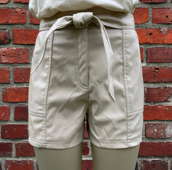 Black faux leather shorts by And The Why, featuring a high-waisted design and sleek, shiny finish.