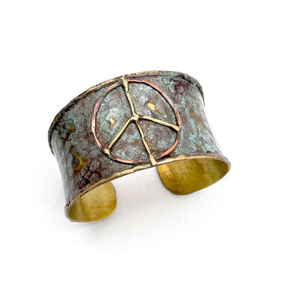 Brass patina cuff bracelet featuring a rustic blue peace sign design from Anju Jewelry, stylish boho accessory.