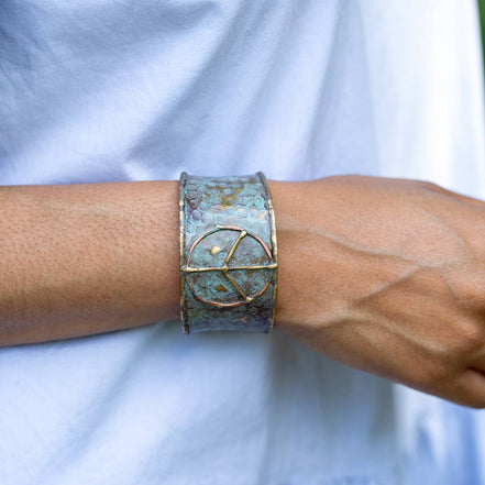 Rustic blue patina brass cuff bracelet featuring a peace sign design by Anju Jewelry