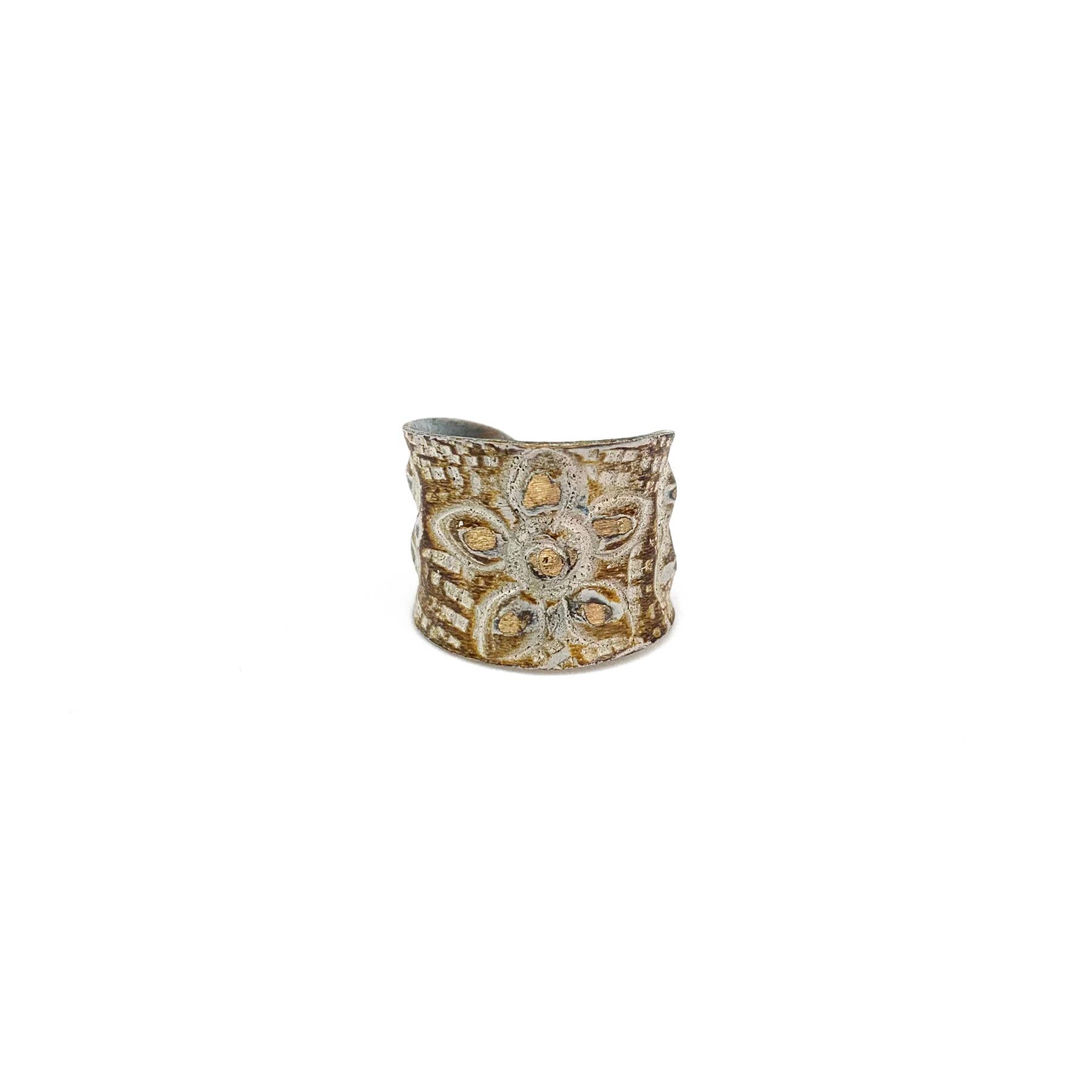 Brass patina ring by Anju Jewelry featuring a large flower design in warm brown and white tones.