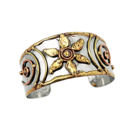 Handcrafted mixed metal cuff bracelet with a floral spiral design by Anju Jewelry, showcasing intricate metalwork and artistic detail.
