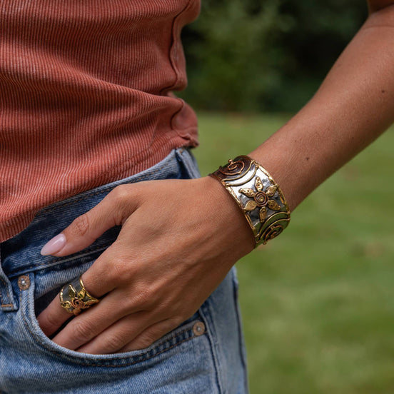 Handcrafted mixed metal cuff bracelet with a flower spiral design from Anju Jewelry, featuring intricate metalwork and artistic details.