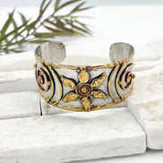 Handcrafted mixed metal cuff bracelet with a flower spiral design by Anju Jewelry. Stylish jewelry accessory.