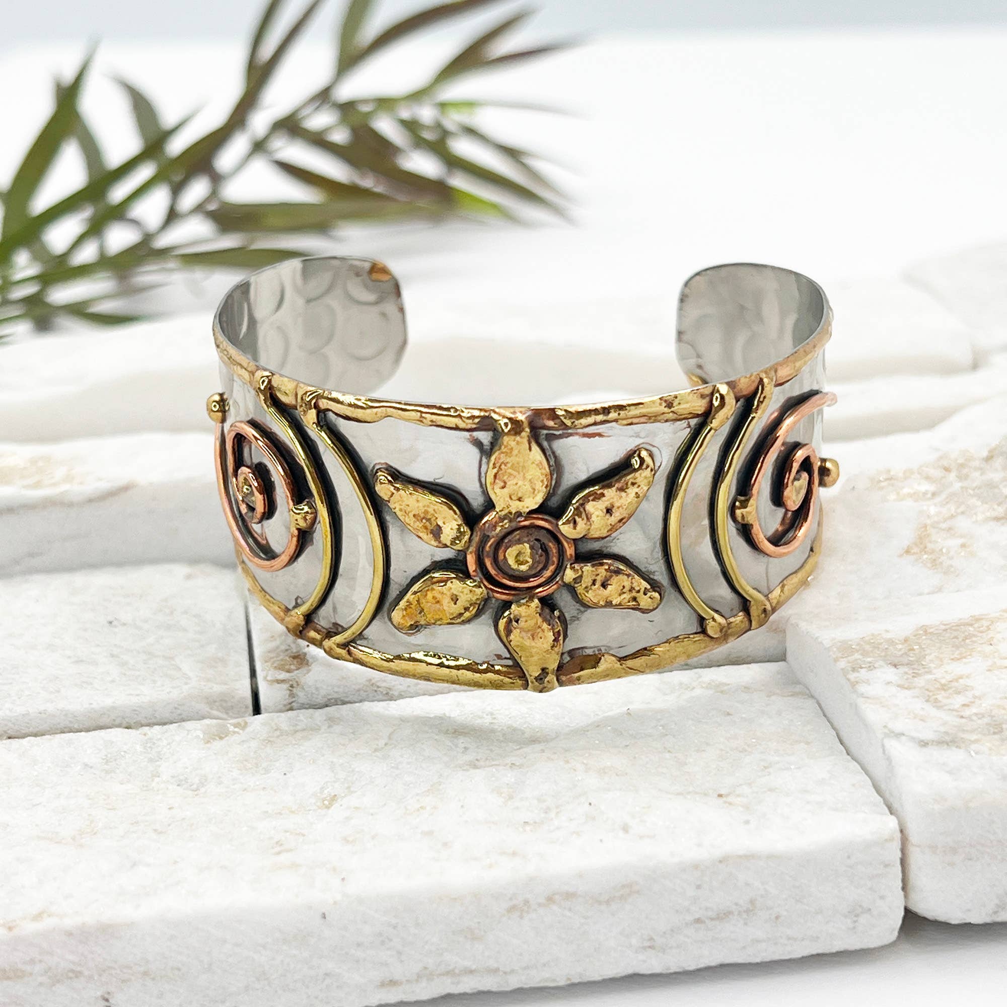 Handcrafted mixed metal cuff bracelet with a flower spiral design by Anju Jewelry. Stylish jewelry accessory.