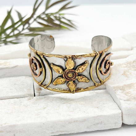 Handcrafted mixed metal cuff bracelet with a flower spiral design by Anju Jewelry. Stylish jewelry accessory.