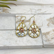Handcrafted mixed metal sun earrings featuring detailed sunburst design by Anju Jewelry.