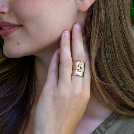 Silver and gold mixed metal ring with spiral cross design by Anju Jewelry, showcasing intricate jewelry craftsmanship.