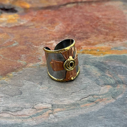 Mixed metal ring with spiral cross design from Anju Jewelry, showcasing a unique jewelry piece with intricate metalwork.
