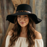 Avenue Zoe boho black felt hat with wide brim and decorative band, stylish accessory for fashion-forward outfits.
