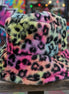 Tie dye leopard patterned faux fur bucket hat by Cap Zone with vibrant, bold animal print and soft fur texture.