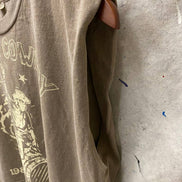 Faded brown Urban Cowboy boxy midriff muscle top with pinned sleeves by Country Deep Apparel, styled casually.