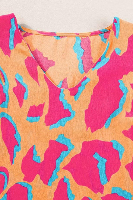 Abstract V-neck blouse with ruffled sleeves from Little Daisy Closet, stylish top featuring a flowy, feminine design.