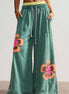 Sea green flower patched drawstring pants by FashionWorks featuring contrast elastic waistband and floral patch details.