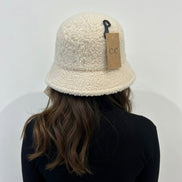 Hana C.C Rubber Patch Sherpa Bucket Hat featuring a soft sherpa fabric and rubber patch detail, perfect for casual outdoor wear.