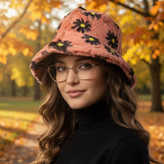 Black floral faux fur bucket hat by Hana with a soft, plush texture and stylish floral pattern.