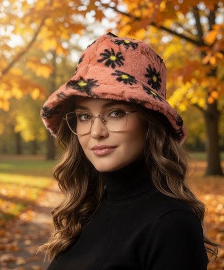 Black floral faux fur bucket hat by Hana with a soft, plush texture and stylish floral pattern.