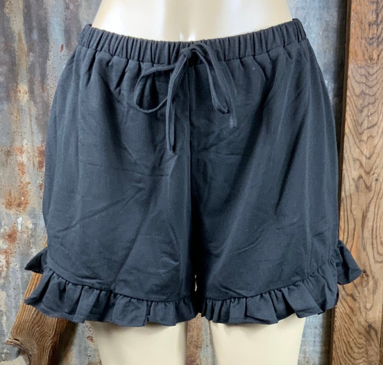 Main Strip brand. Drawstring tie waisted shorts with ruffled bottom hem. Loose fit. Available in Dusty Rose and Black.
